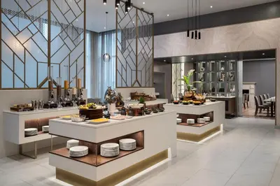 a restaurant with a buffet line with dishes at Cape Town Marriott Hotel Crystal Towers in Cape Town