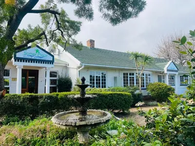 a house with a fountain in front of it at Somer Place B&B in Somerset West