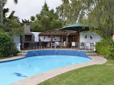 a swimming pool in the backyard of a house at Somer Place B&B in Somerset West