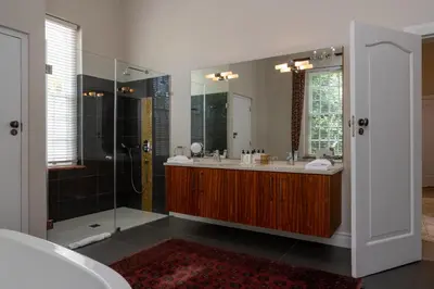 a bathroom with a shower and a sink and a tub at Wild Mushroom Country House in Stellenbosch