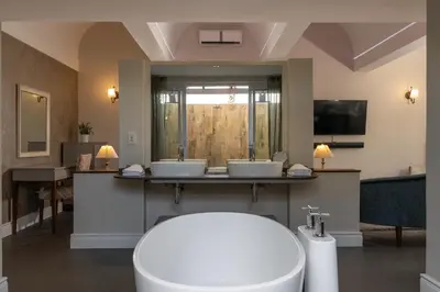 a bathroom with two sinks and a large mirror at Wild Mushroom Country House in Stellenbosch