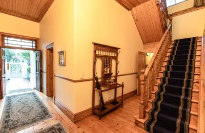 a hallway with a staircase in a house at Evergreen Manor and Spa in Stellenbosch