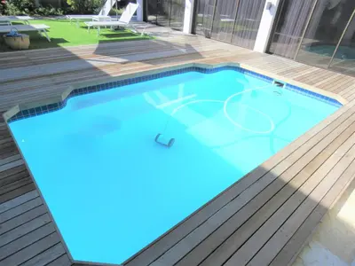 a swimming pool with a basketball court in the middle at OCEAN BREEZE SUNSET BEACH - Cape Town in Cape Town