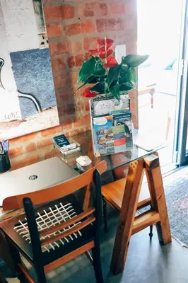 a desk with a chair and a table with a plant at Stay At Friends in Bettyʼs Bay