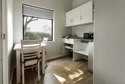 a kitchen with a table and chairs and a window at Bona Vista Self-Catering Accommodation in Klapmuts