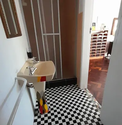 a bathroom with a sink and a checkered floor at John Bauer Pottery Studio in Cape Town