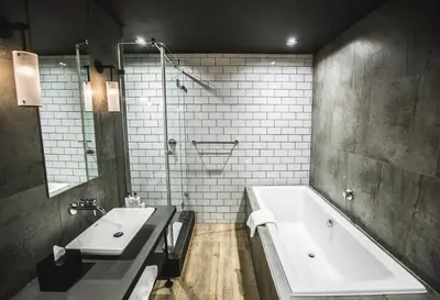 a bathroom with two sinks and a bath tub at Century City Hotel Urban Square in Cape Town