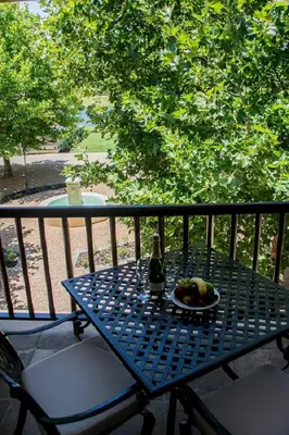 a table with a bottle of beer and a plate of fruit at ASARA Wine Estate & Hotel in Stellenbosch