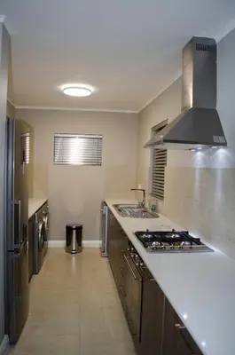 a kitchen with a sink and a stove at Mayfair Luxury Apartments in Cape Town