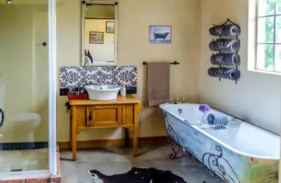 a bathroom with a large tub and a sink at Seven Oaks Vineyard Cottages in Wolseley