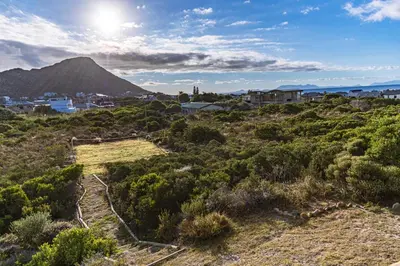 a view of a hill with a mountain in the background at The Mermaid's Tail in Pringle Bay