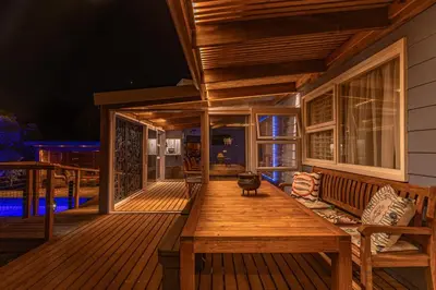 a wooden deck with a bench on a house at The Mermaid's Tail in Pringle Bay