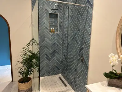 a shower in a bathroom with a blue tiled wall at Residence Vive la Vie in Franschhoek