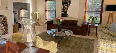 a living room with a couch and a table at Residence Vive la Vie in Franschhoek