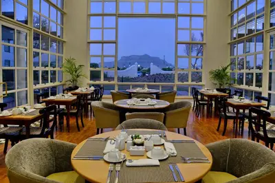 a restaurant with tables and chairs and large windows at City Lodge Hotel GrandWest in Epping
