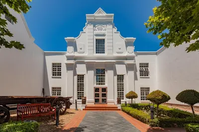 a large white building with a clock tower at City Lodge Hotel GrandWest in Epping