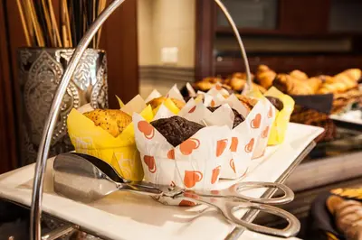 a bunch of pastries on a table with a pair of scissors at City Lodge Hotel Pinelands in Cape Town