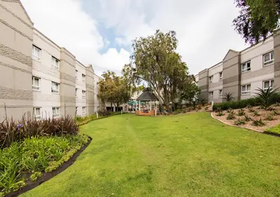 a courtyard of an apartment building with a gazebo at City Lodge Hotel Pinelands in Cape Town