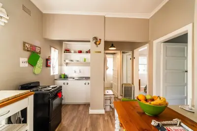 a kitchen with a bowl of fruit on a wooden floor at Belfield Wines and Farm Cottages in Grabouw