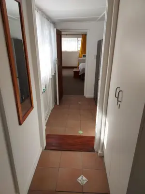 a hallway with a tile floor in a room at Rose Cottage in Hermanus