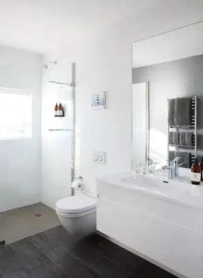 a white bathroom with a toilet and a sink at One Marine Drive Boutique Hotel & Spa by The Living Journey Collection in Hermanus