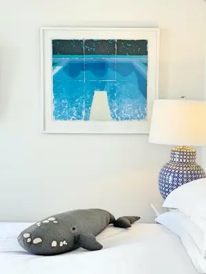 a stuffed whale laying on a bed next to a lamp at One Marine Drive Boutique Hotel & Spa by The Living Journey Collection in Hermanus