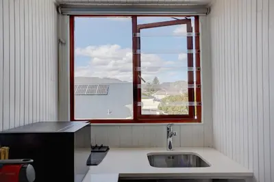 a kitchen with a sink and a window at Beautiful Abalone in Hermanus