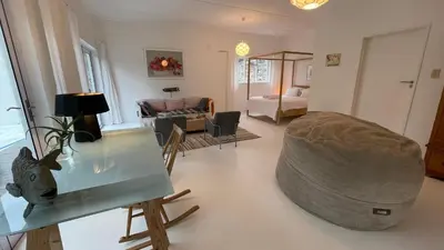 a living room with a couch and a table at Pashasha Beach House and Hot Tub in Hermanus
