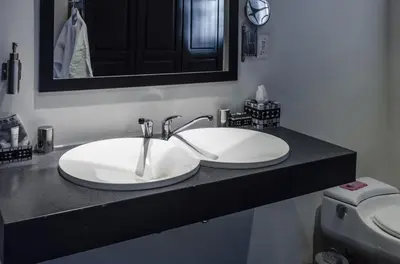 a bathroom counter with a sink and a toilet at KaapsePracht Bed & Breakfast in Somerset West