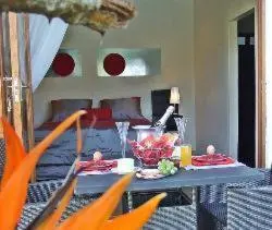 a living room with a table with food on it at KaapsePracht Bed & Breakfast in Somerset West