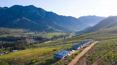 an aerial view of a farm in a mountain valley at Big Sky Cottages in Wolseley