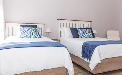 two beds sitting next to each other in a bedroom at 10 Windell Self Catering Accommodation in Durbanville