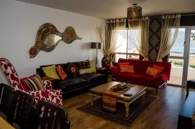 a living room with two couches and a table at Greenways Emerald Bay in Strand