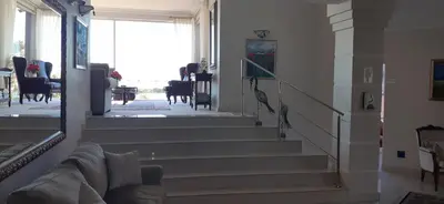 a living room with stairs leading to a dining room at Cinnamon House Bed & Breakfast in Cape Town