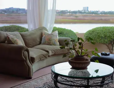 a living room with a couch and a table at Cinnamon House Bed & Breakfast in Cape Town