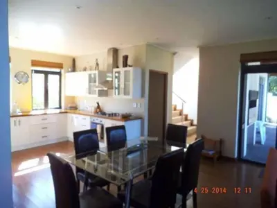 a dining room with a glass table and chairs at Riverside 18 in Hermanus