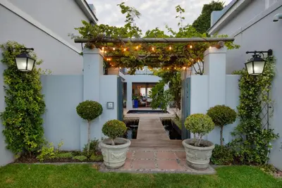 an entrance to a house with a pathway with plants and lights at Strand Beach Lodge in Strand