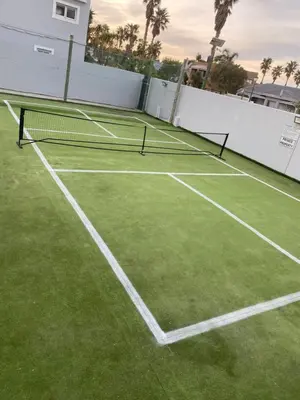 a tennis court with two tennis nets on it at Strand Beach Lodge in Strand