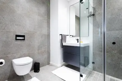 a bathroom with a toilet and a sink and a shower at De Zalze Lodge in Stellenbosch
