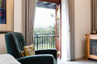 a living room with a view of a balcony at De Zalze Lodge in Stellenbosch