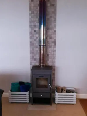 a fireplace with a stove in a room at Sit-en-Kyk in Hermanus