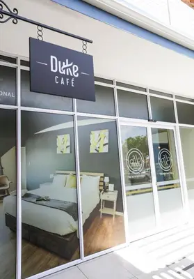 a sign for a dixie cafe in a store window at New National Hotel and Conference in Parow
