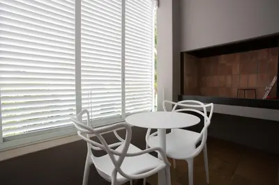 a table and chairs in a room with a window at Laanhof Studios in Stellenbosch