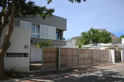 a house with a wooden gate and a fence at Laanhof Studios in Stellenbosch