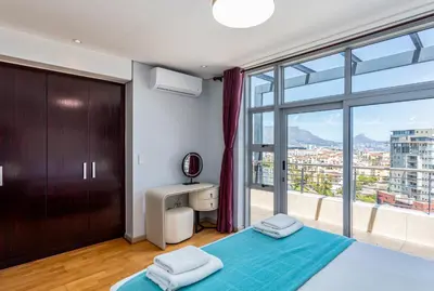 a bedroom with a bed and a large window at Knightsbridge Luxury Suite in Century City by CTHA in Cape Town