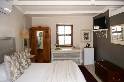 a bedroom with a white bed and a window at Madeliefie Guest Accommodation in Paarl