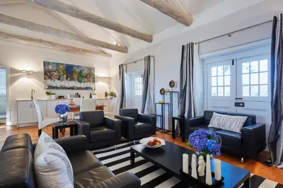 a living room with a couch and a table at Allèe Bleue Wine Estate in Simondium