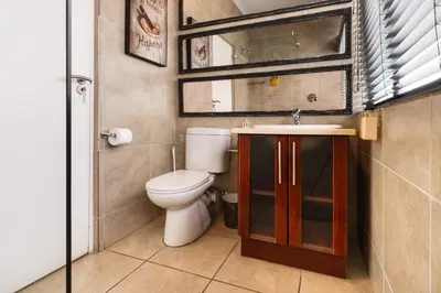 a bathroom with a toilet and a sink at Avemore Eikehoff No 24 full back up power in Stellenbosch