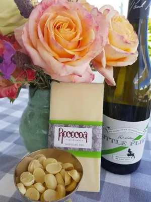a bottle of wine and a bowl of peanuts at Paul Wallace Wines & Cottages in Elgin
