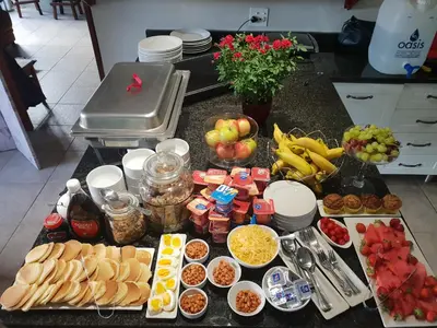 a table with many different types of food on it at Dilisca Guesthouse in Durbanville